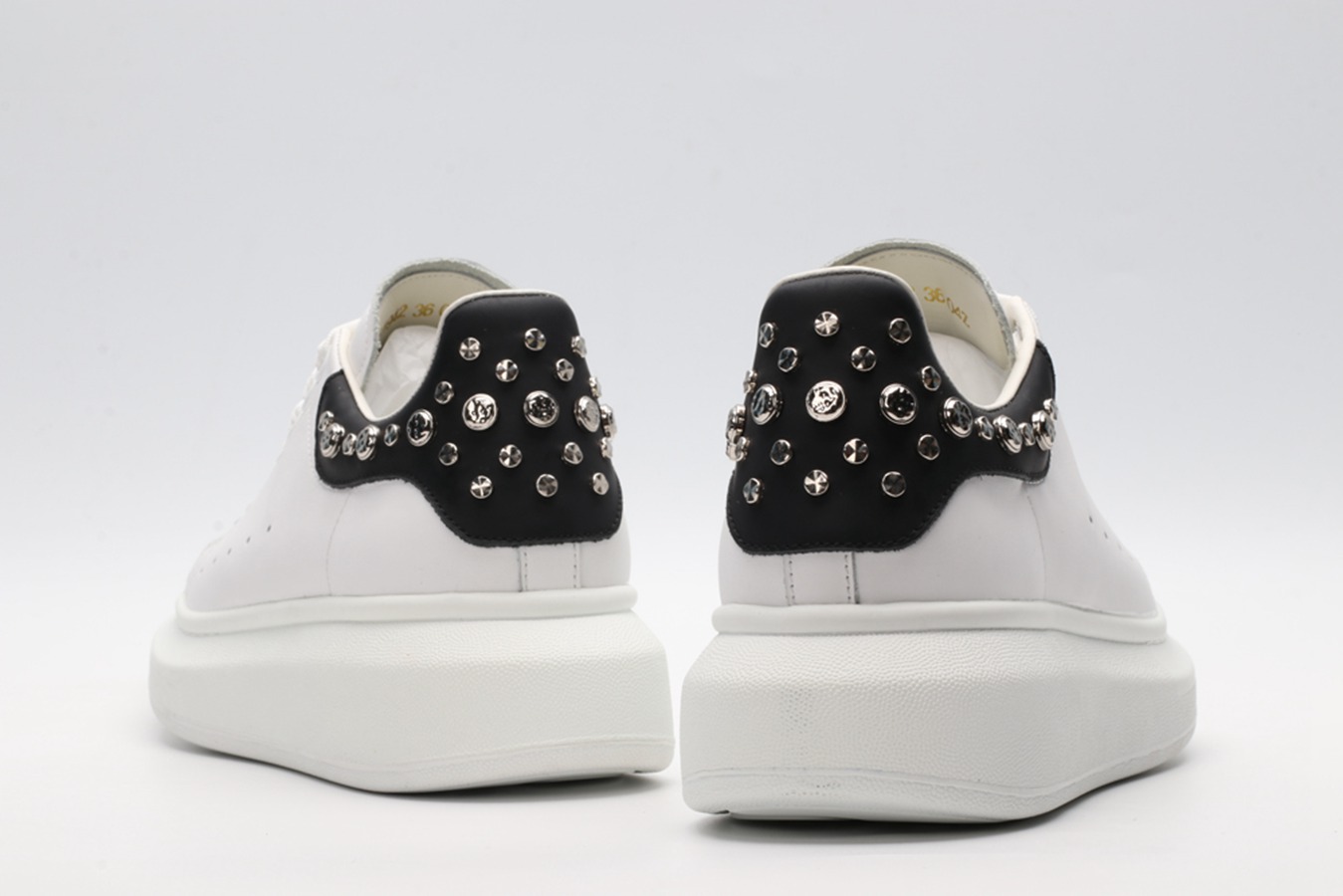 White calf leather lace-up sneaker trimmed with contrasting-color black calf leather heel