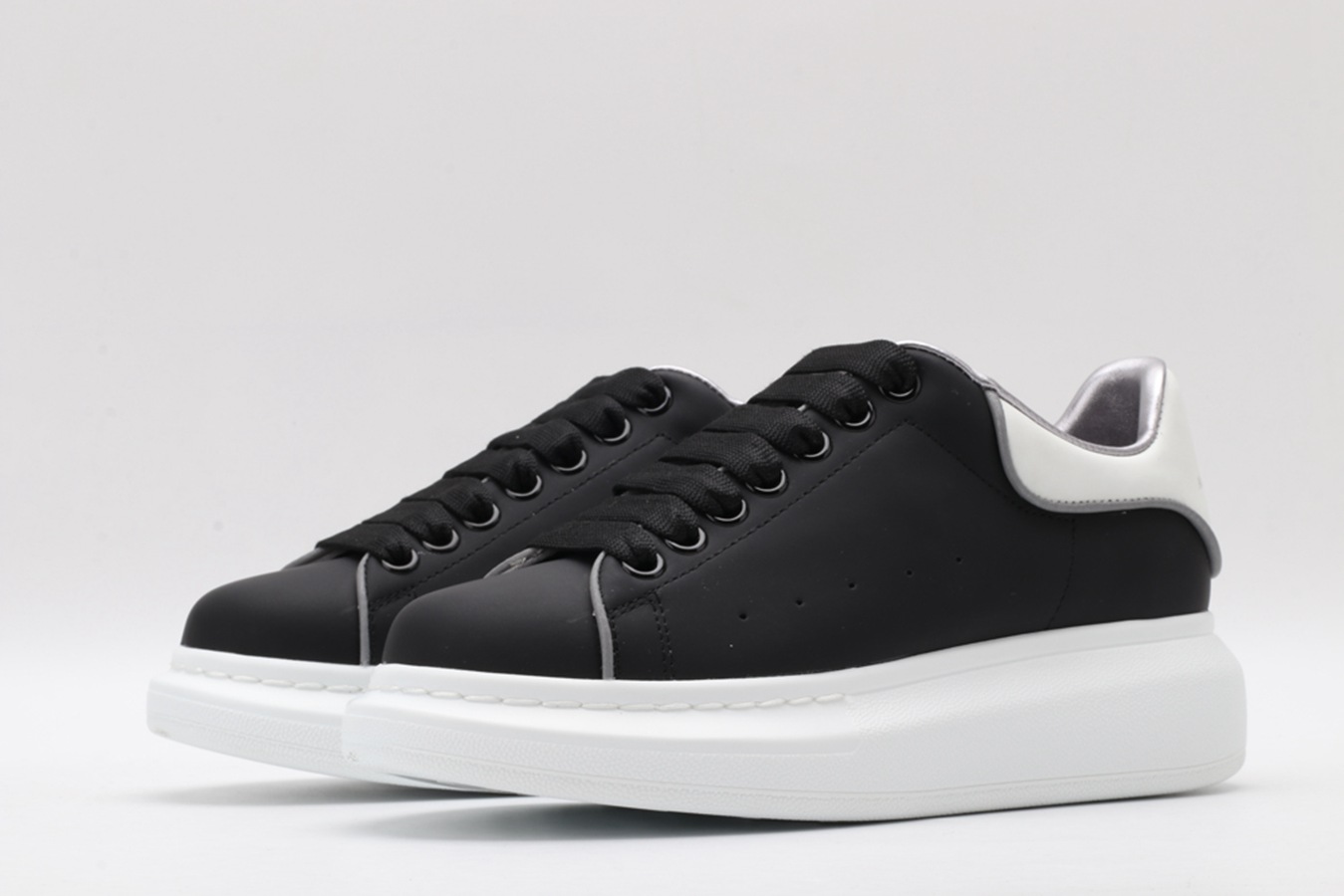 AMQ oversized black sneakers with white heel