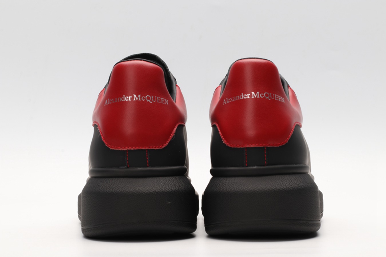 AMQ black oversized sneakers with red heel