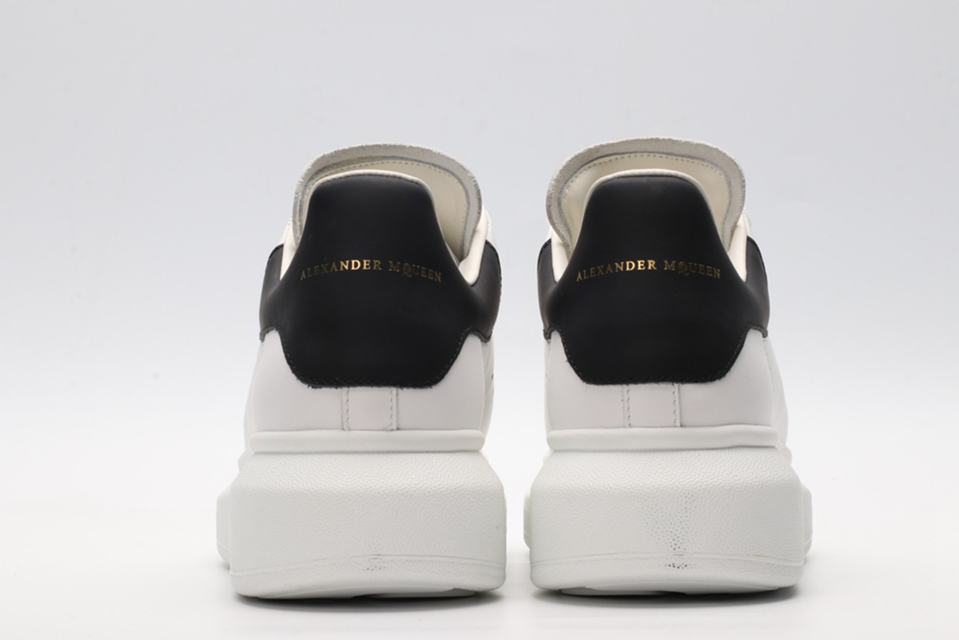 AMQ white oversized sneakers with black heel